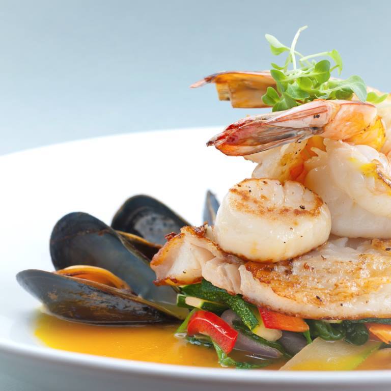 "Seafood medley of shrimp, scallops, mussels and fresh fish over a bed of vegetables."